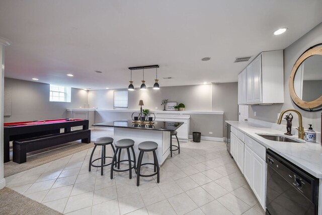 1N183 Stacy Ct, Glen Ellyn, IL 60137 - kitchen with black dishwasher, a kitchen breakfast bar, white cabinetry, a kitchen island, and light tile patterned flooring