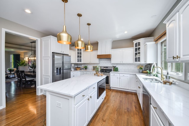 1N183 Stacy Ct, Glen Ellyn, IL 60137 - kitchen featuring stainless steel appliances, a kitchen island, wood finished floors, backsplash, and white cabinets