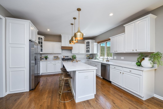 1N183 Stacy Ct, Glen Ellyn, IL 60137 - kitchen featuring stainless steel appliances, white cabinets, glass insert cabinets, a kitchen breakfast bar, and a center island