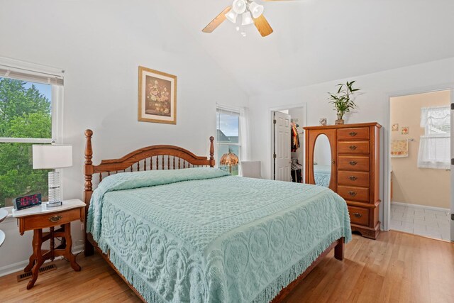 1239 Spring Creek Rd, Elgin, IL 60120 - bedroom featuring light wood-style flooring, a spacious closet, a closet, a ceiling fan, and high vaulted ceiling