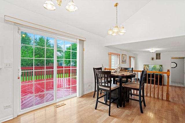 1239 Spring Creek Rd, Elgin, IL 60120 - dining space with a chandelier, light wood-type flooring, and vaulted ceiling