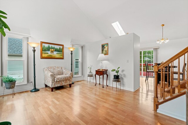 1239 Spring Creek Rd, Elgin, IL 60120 - sitting room with stairs, high vaulted ceiling, light wood finished floors, a skylight, and baseboards