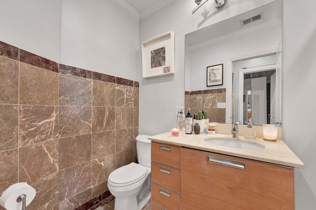 3034 W N Ave Unit 2, Chicago, IL 60647 - bathroom with tile walls, crown molding, toilet, vanity, and wainscoting