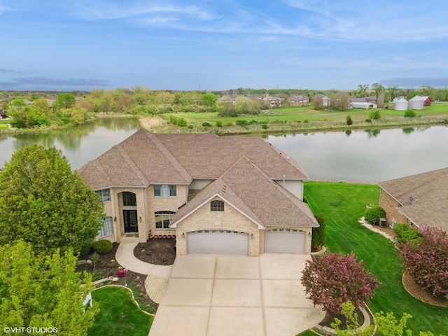 22844 Lakeview Estates Blvd, Frankfort, IL 60423 - view of front facade featuring driveway, a water view, a garage, a front lawn, and roof with shingles