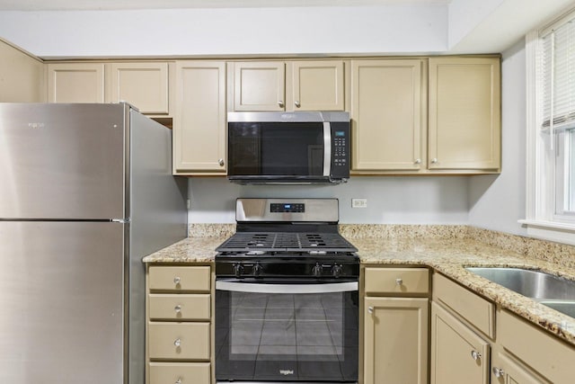1819 W Touhy Ave Unit 2, Chicago, IL 60626 - kitchen with stainless steel appliances, cream cabinets, and light stone countertops