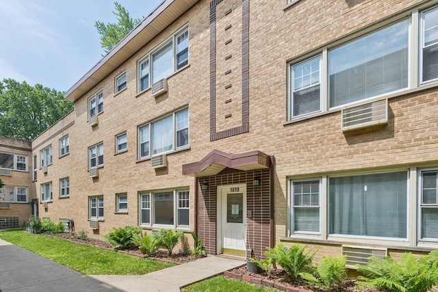 1819 W Touhy Ave Unit 2, Chicago, IL 60626 - view of building exterior featuring a wall mounted air conditioner