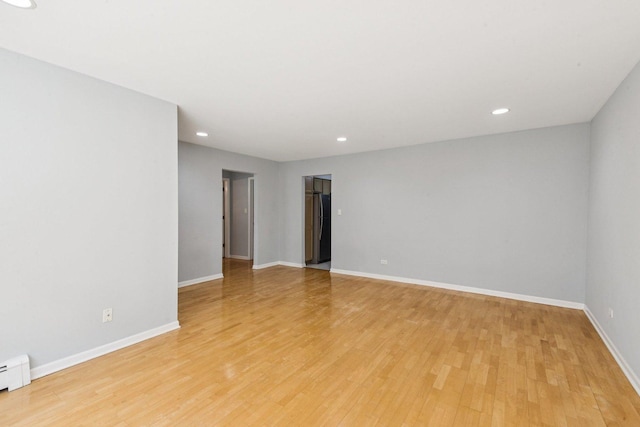 1819 W Touhy Ave Unit 2, Chicago, IL 60626 - unfurnished room with light wood-style flooring, recessed lighting, baseboards, and a baseboard radiator