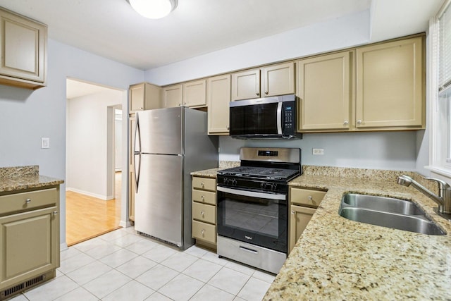 1819 W Touhy Ave Unit 2, Chicago, IL 60626 - kitchen with stainless steel appliances, a sink, light stone countertops, and light tile patterned floors