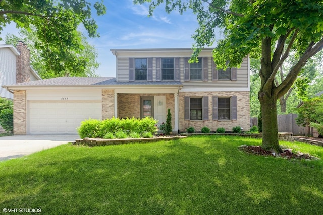 8885 Dryden St, Woodridge, IL 60517 - traditional home featuring an attached garage, concrete driveway, and brick siding