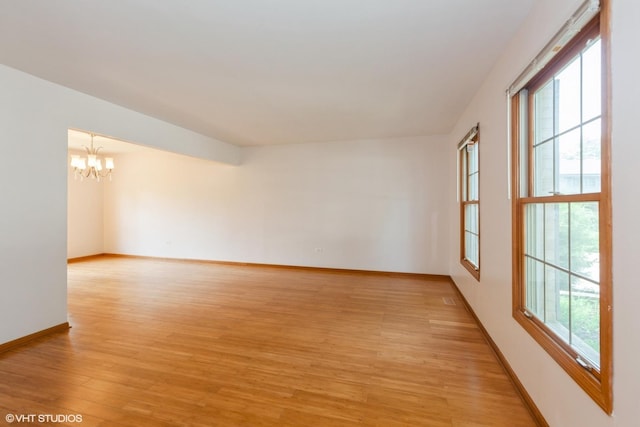 8885 Dryden St, Woodridge, IL 60517 - unfurnished room with a chandelier, healthy amount of natural light, and light wood-type flooring
