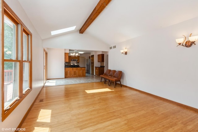 8885 Dryden St, Woodridge, IL 60517 - unfurnished living room with a chandelier, a skylight, light wood finished floors, and healthy amount of natural light