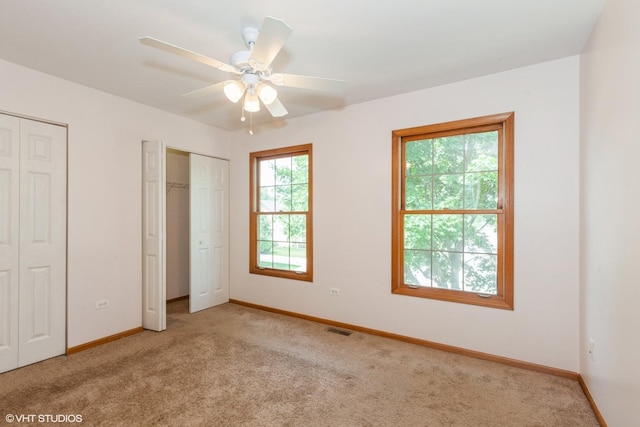 8885 Dryden St, Woodridge, IL 60517 - unfurnished bedroom featuring two closets, light colored carpet, baseboards, and a ceiling fan