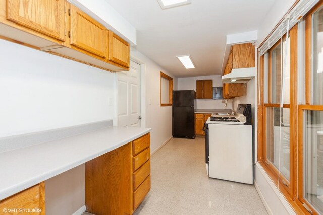 8885 Dryden St, Woodridge, IL 60517 - kitchen featuring white gas stove, freestanding refrigerator, light floors, light countertops, and baseboards