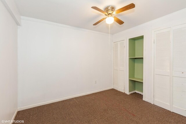 8885 Dryden St, Woodridge, IL 60517 - unfurnished bedroom featuring carpet flooring, multiple closets, baseboards, and a ceiling fan