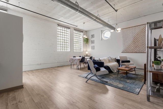 519 N Hickory St Unit 519, Champaign, IL 61820 - living room featuring brick wall and wood finished floors