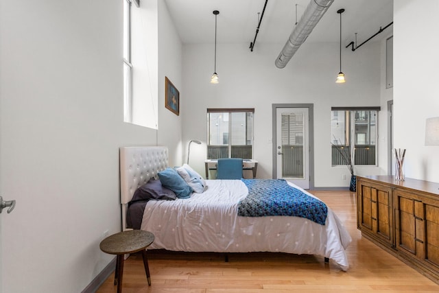 519 N Hickory St Unit 519, Champaign, IL 61820 - bedroom with a high ceiling, wood finished floors, and baseboards