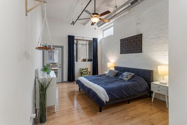 519 N Hickory St Unit 519, Champaign, IL 61820 - bedroom with a high ceiling, light wood-type flooring, brick wall, access to outside, and a ceiling fan