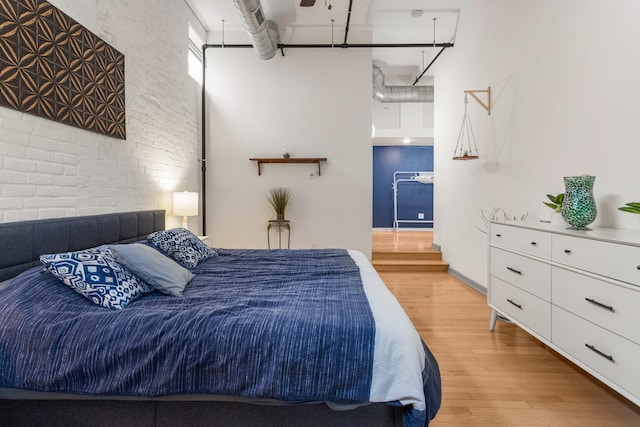 519 N Hickory St Unit 519, Champaign, IL 61820 - bedroom featuring brick wall, wood finished floors, and a towering ceiling