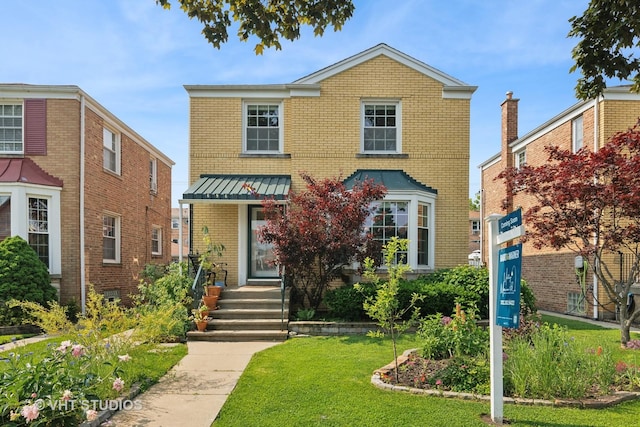 6967 W Wolfram St, Chicago, IL 60634 - view of front of property with brick siding, a standing seam roof, a front lawn, and a metal roof