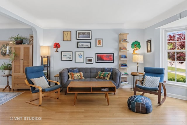 6967 W Wolfram St, Chicago, IL 60634 - living room featuring light wood finished floors and arched walkways