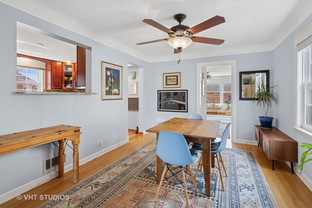6967 W Wolfram St, Chicago, IL 60634 - dining room featuring ceiling fan, healthy amount of natural light, and light wood-style flooring
