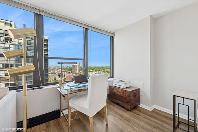 1560 N Sandburg Ter Unit 1605J, Chicago, IL 60610 - dining space featuring wood finished floors, a view of city, baseboards, an office area, and floor to ceiling windows