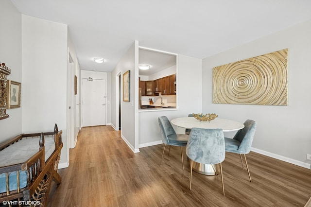 1560 N Sandburg Ter Unit 1605J, Chicago, IL 60610 - dining space featuring wood finished floors and baseboards