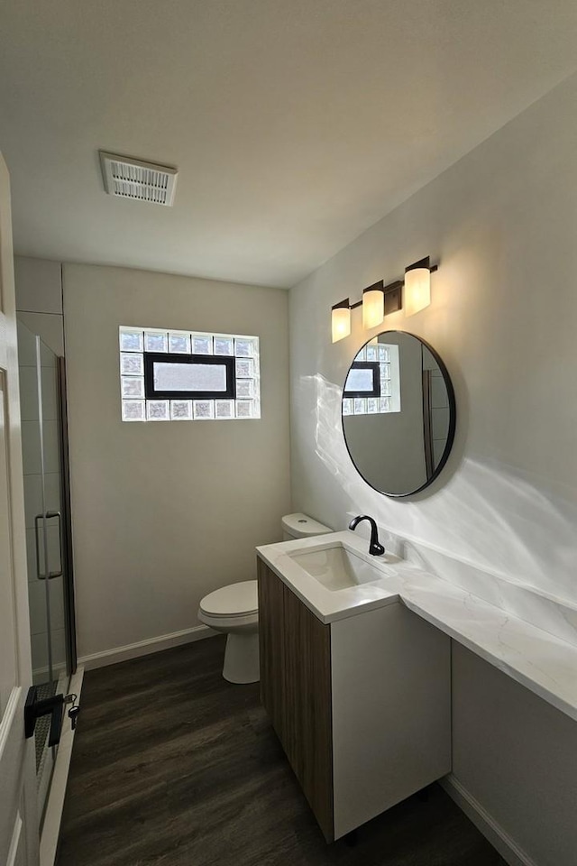 3912 W Hayford St, Chicago, IL 60652 - full bathroom with plenty of natural light, vanity, wood finished floors, and toilet