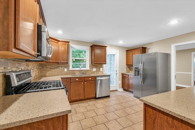 1204 Mayfair Rd, Champaign, IL 61821 - kitchen featuring stainless steel appliances, tasteful backsplash, light tile patterned floors, brown cabinetry, and recessed lighting