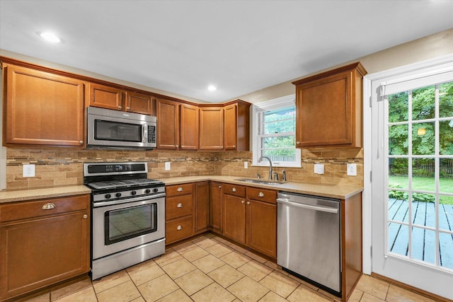 1204 Mayfair Rd, Champaign, IL 61821 - kitchen with appliances with stainless steel finishes, brown cabinets, light tile patterned floors, decorative backsplash, and recessed lighting