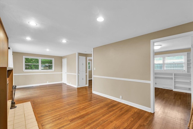 1204 Mayfair Rd, Champaign, IL 61821 - unfurnished living room with wood finished floors and recessed lighting