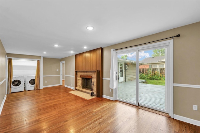 1204 Mayfair Rd, Champaign, IL 61821 - unfurnished living room with a fireplace with flush hearth, washer and dryer, light wood-style floors, and recessed lighting