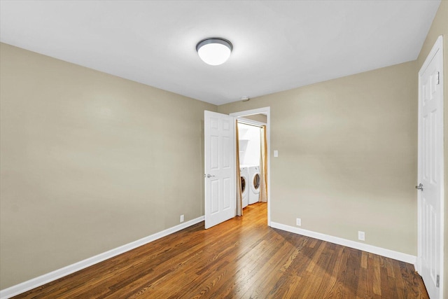 1204 Mayfair Rd, Champaign, IL 61821 - unfurnished bedroom with washing machine and dryer and dark wood-style floors