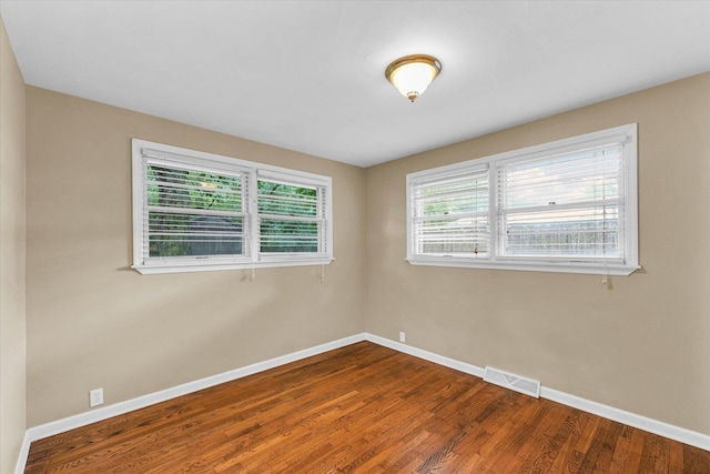 1204 Mayfair Rd, Champaign, IL 61821 - unfurnished room with baseboards and dark wood-style floors