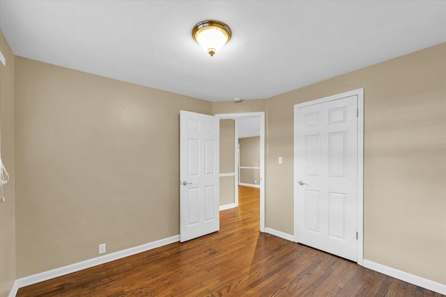 1204 Mayfair Rd, Champaign, IL 61821 - unfurnished bedroom with wood finished floors and baseboards