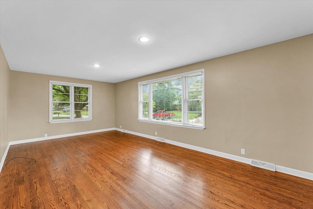 1204 Mayfair Rd, Champaign, IL 61821 - empty room with wood finished floors and recessed lighting