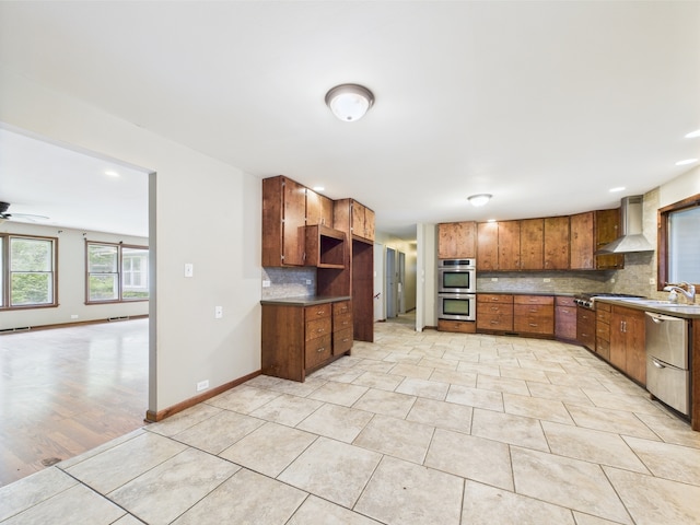 2208 Fiesta Dr, Joliet, IL 60432 - kitchen with wall chimney exhaust hood, appliances with stainless steel finishes, decorative backsplash, ceiling fan, and light tile patterned floors