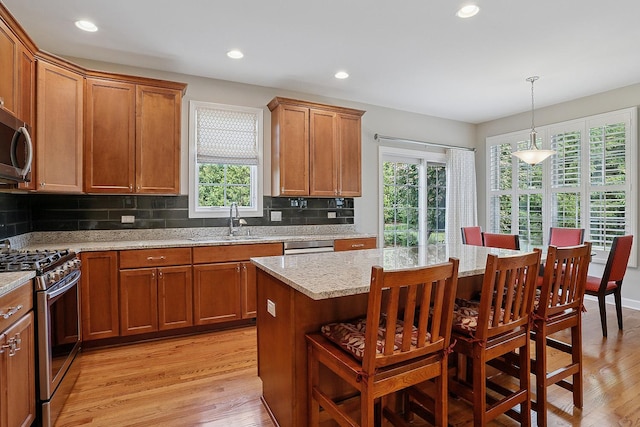 1250 Ashbury Pl Unit 1250, Lemont, IL 60439 - kitchen featuring appliances with stainless steel finishes, a sink, healthy amount of natural light, brown cabinets, and recessed lighting