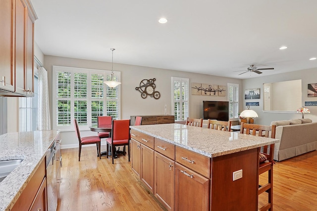 1250 Ashbury Pl Unit 1250, Lemont, IL 60439 - kitchen featuring a kitchen bar, light wood finished floors, open floor plan, and recessed lighting