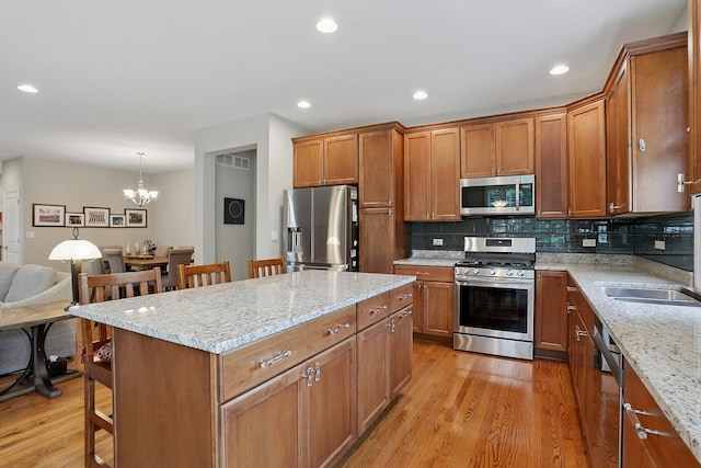 1250 Ashbury Pl Unit 1250, Lemont, IL 60439 - kitchen featuring stainless steel appliances, a breakfast bar area, brown cabinets, and recessed lighting