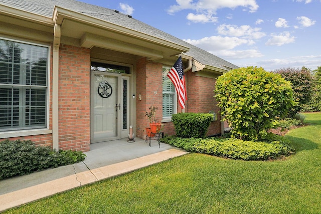 1250 Ashbury Pl Unit 1250, Lemont, IL 60439 - property entrance with brick siding, a shingled roof, and a yard