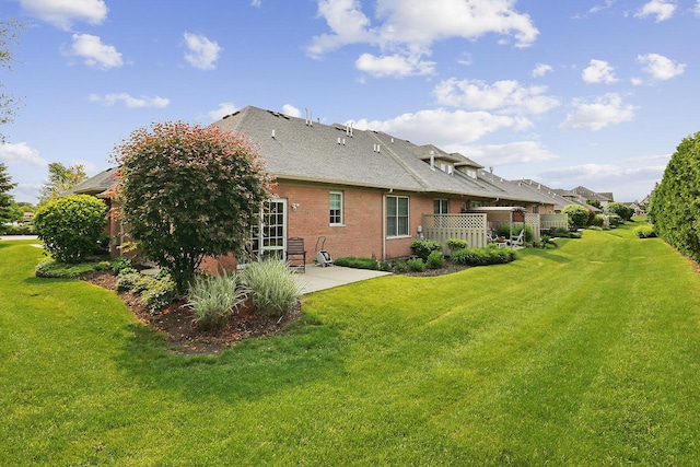1250 Ashbury Pl Unit 1250, Lemont, IL 60439 - back of house with a patio area, brick siding, a yard, and roof with shingles