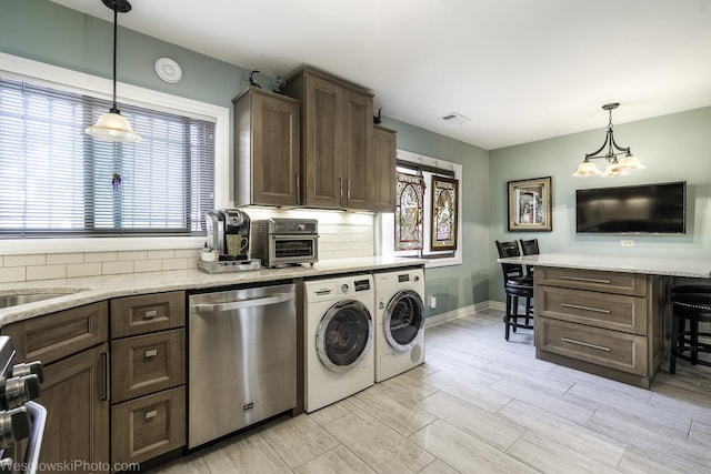 4876 N Hermitage Ave Unit 104, Chicago, IL 60640 - kitchen featuring dishwasher, washer and clothes dryer, tasteful backsplash, stove, and dark brown cabinetry