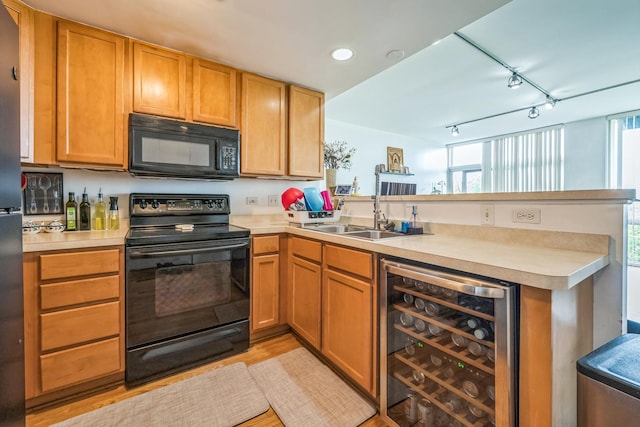 61 W 15th St Unit 407, Chicago, IL 60605 - kitchen with black appliances, wine cooler, a peninsula, a sink, and rail lighting