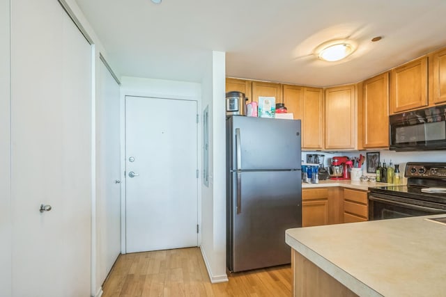 61 W 15th St Unit 407, Chicago, IL 60605 - kitchen with black appliances, light wood finished floors, and light countertops