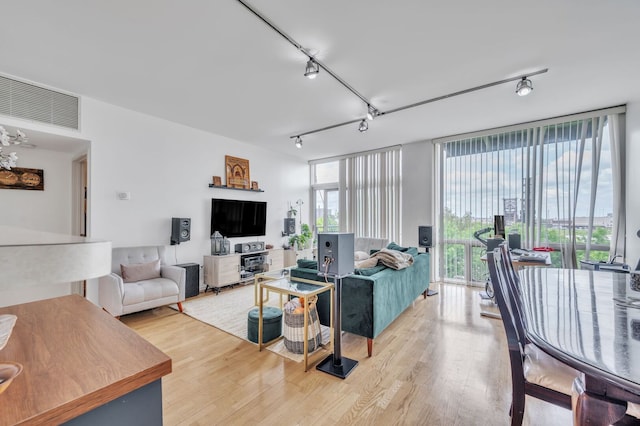 61 W 15th St Unit 407, Chicago, IL 60605 - living room with light wood-type flooring, rail lighting, and a wall of windows