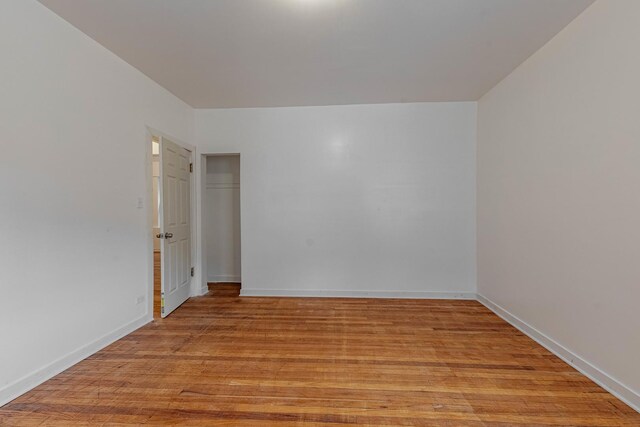 7353 S Martin Luther King Dr, Chicago, IL 60619 - spare room featuring light wood-type flooring and baseboards
