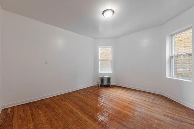 7353 S Martin Luther King Dr, Chicago, IL 60619 - unfurnished room featuring radiator, wood finished floors, and baseboards