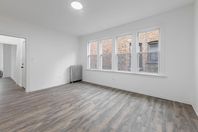 7353 S Martin Luther King Dr, Chicago, IL 60619 - spare room with radiator heating unit, dark wood-style flooring, and baseboards