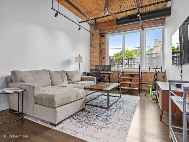 1725 W N Ave Unit 204, Chicago, IL 60622 - living area featuring brick wall, wood ceiling with exposed beams, dark wood-type flooring, a towering ceiling, and a ceiling fan